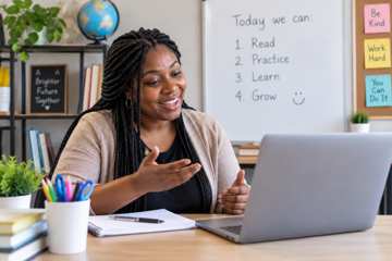 Black woman educator teaching English online from a bright professional home classroom